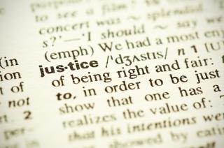 Close-up of the word justice in the dictionary