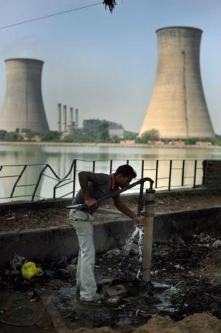A Man Collects Water from a Well be-side a Lake near the Guru Nanak Dev Thermal Power Plant