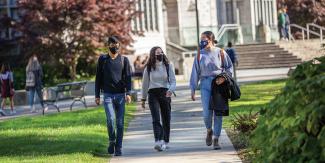 Students walking outside with facemasks