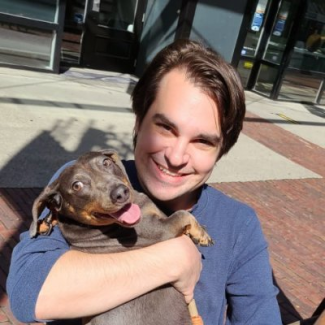 Allard Law doctoral student Mark Mancini with his wiener dog, Hugo.