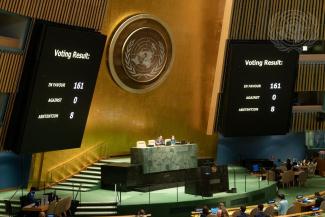 picture of UN with voting screens on wall 