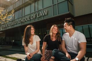 3 students in front of Allard Hall