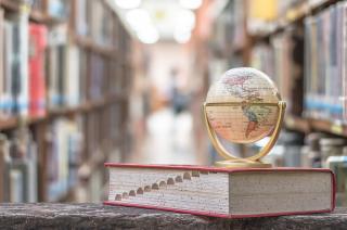 A globe on top of a book in the library