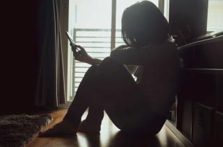 woman with phone in shadow
